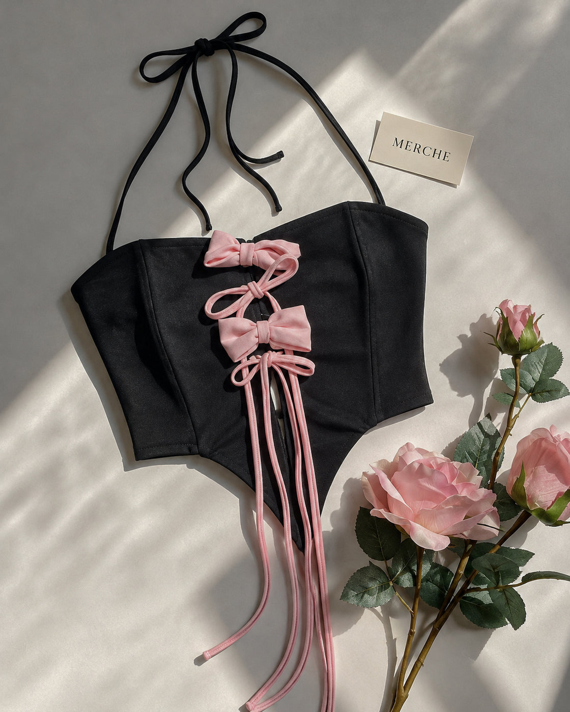 HALO AFTER DARK BOW APPLIQUE ASYMMETRICAL HALTERNECK TOP